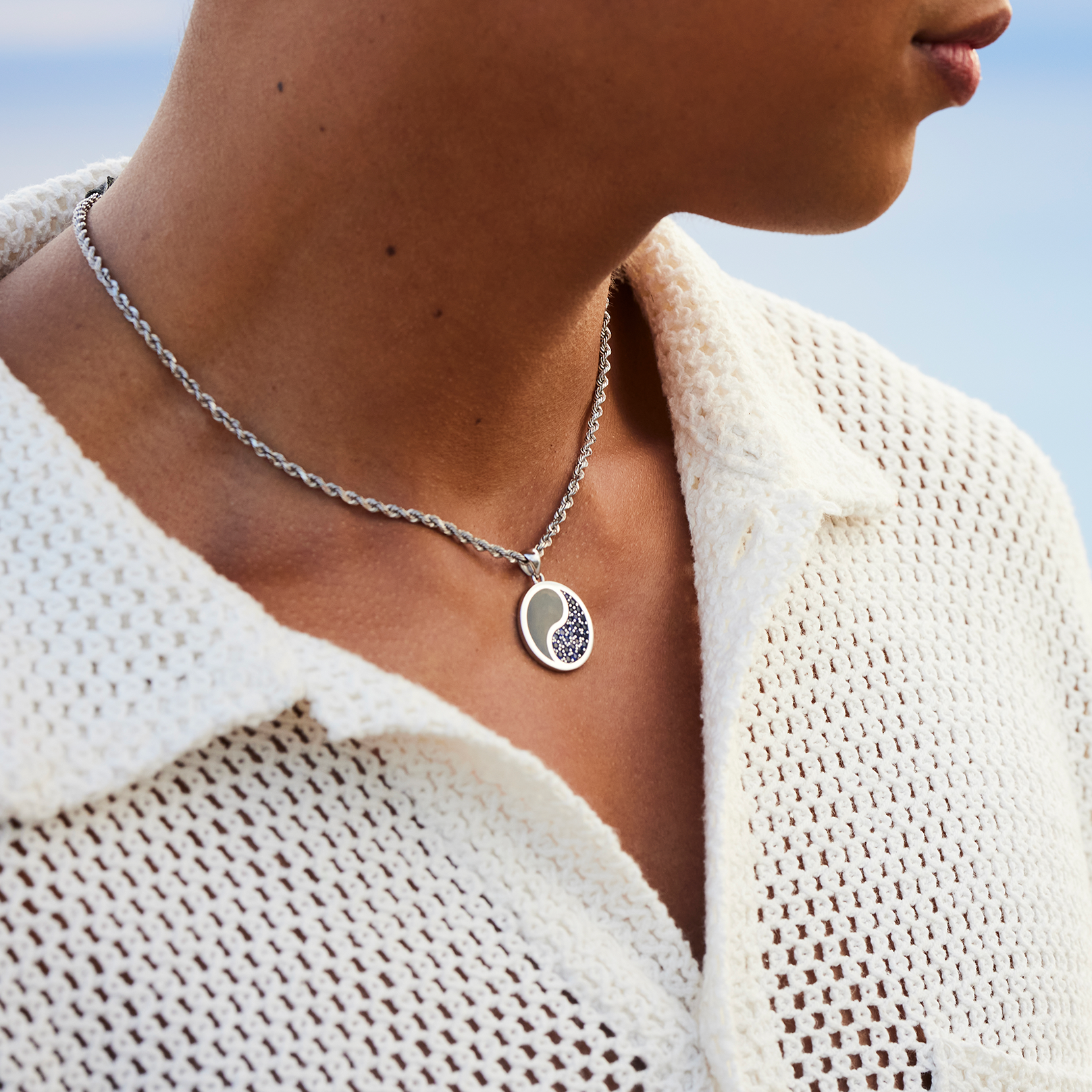 Man wearing 2.5mm Rope Chain in 14k White Gold and Yin Yang pendant with a blue sky in the back