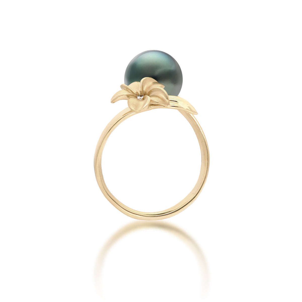 Side view of a 14k yellow gold bypass ring featuring a 10-11mm Tahitian black pearl and diamond-accented plumeria with a satin finish and diamond-cut leaf, set against a clean white background with a soft reflection.