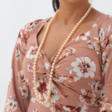A woman wearing a 38" Peach Pearl Freshwater Pearl Strand - Maui Divers Jewelry