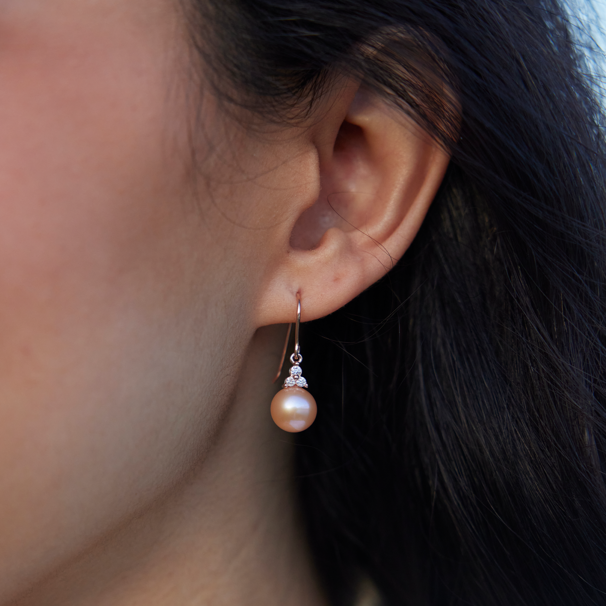 Close up of Peach Freshwater Pearl Earrings in Rose Gold with Diamonds on Model