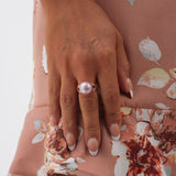 A womanʻs hand with a Lilac Freshwater Pearl Ring in Rose Gold with Diamonds - 12-13mm - Maui Divers Jewelry