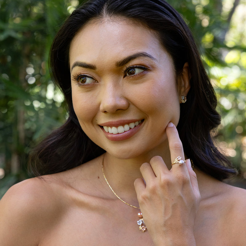 Smiling woman showing her Pearls in Bloom Plumeria Lavender Freshwater Pearl Ring in Two Tone Gold with Diamond