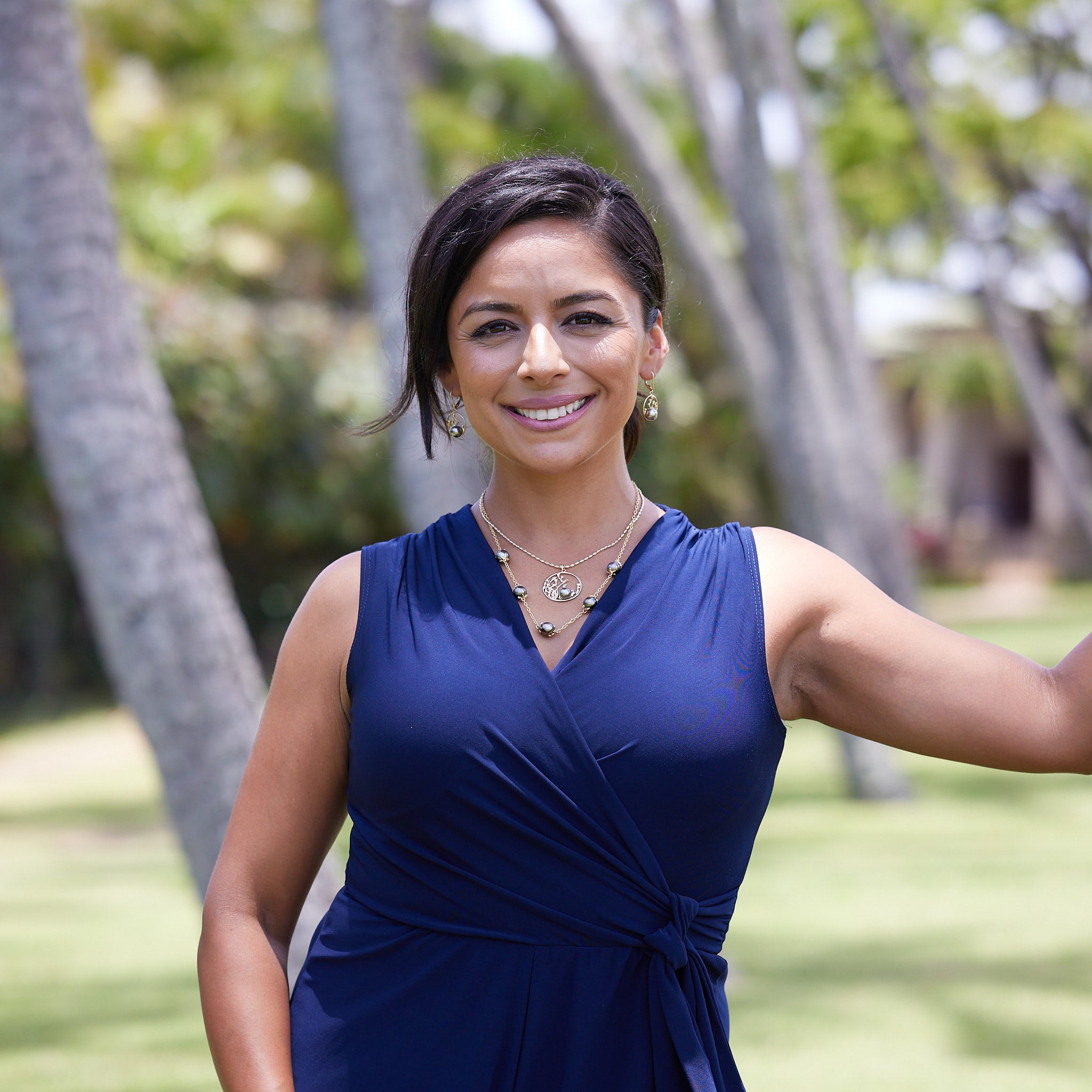 A woman wearing Reefs Tahitian Black Pearl Earrings in Gold with Diamonds - 9-10mm - Maui Divers Jewelry