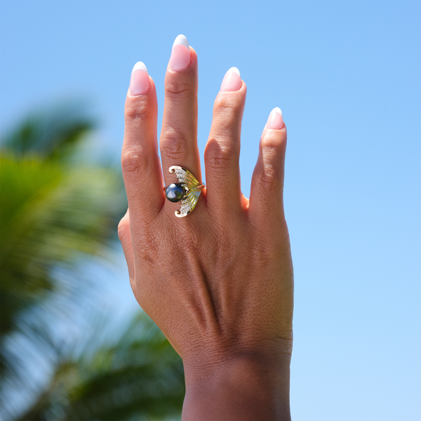 A woman's hand wearing a Moon Mermaid Tahitian Black Pearl Ring in Gold with Diamonds - 9-10mm - Maui Divers Jewelry
