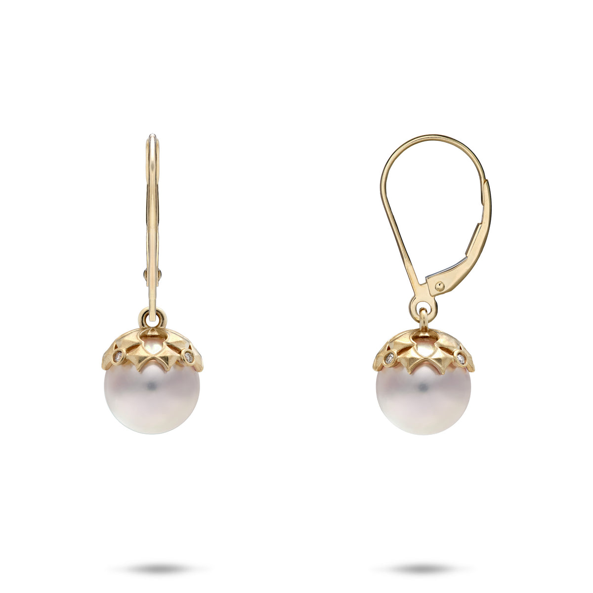 A pair of 14k yellow gold 8mm Akoya white pearl leverback earrings with a Hawaiian quilted star pattern at the top of the pearl with diamond accents, shown with a front and side profile view, on a white background