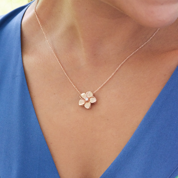 A woman's chest with a Plumeria Pendant in Rose gold with Diamond - 16mm - Maui Divers Jewelry