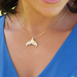A woman's chest with a Moon Mermaid Tail Pendant in Gold with Diamonds - 20mm - MauiDivers Jewelry