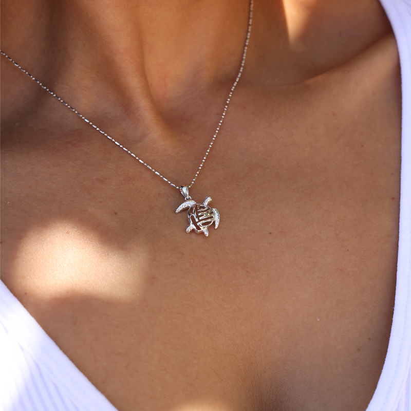 1.0mm Bar Ball Chain in White Gold with Honu Pendant on Chest with White Shirt
