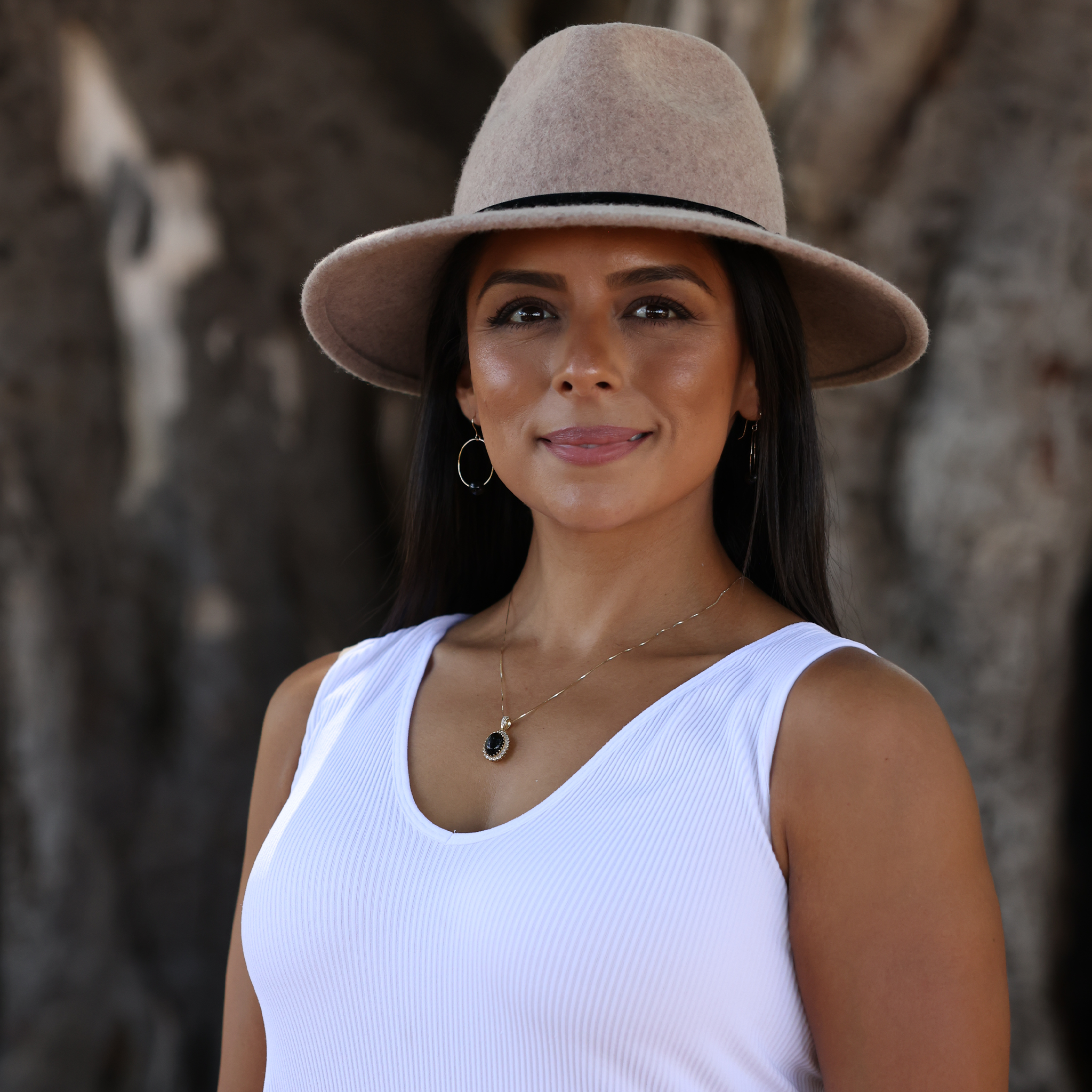 Maui Divers Jewelry Princess Ka‘iulani Black Coral Pendant in Gold with Diamonds on Model with Hat and tree background