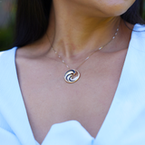 close up of Nalu Black Coral Pendant in Gold - 22mm on model