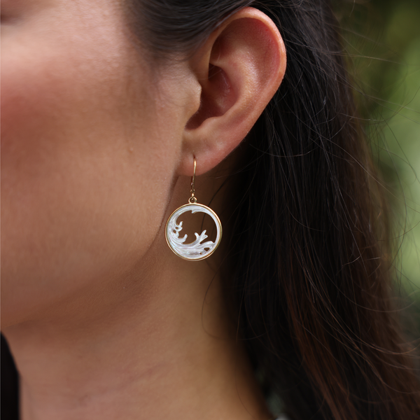 A womanʻs ear with Nalu Splash Mother of Pearl Earrings in Gold - 22mm - Maui Divers Jewelry