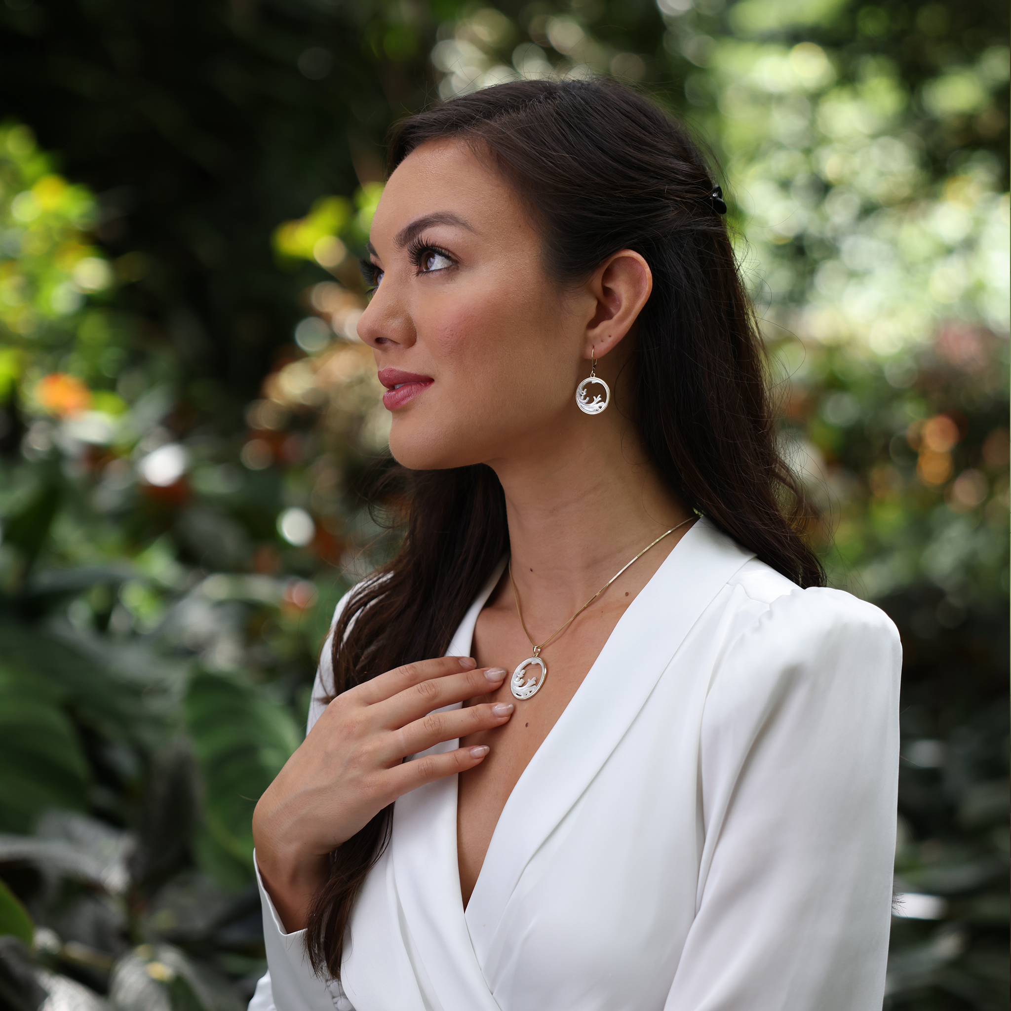 A woman wearing Nalu Splash Mother of Pearl Earrings and Necklace in Gold - Maui Divers Jewelry