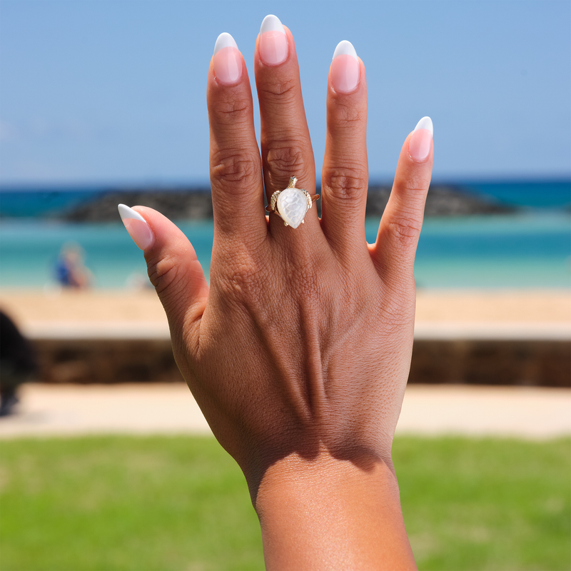 A woman's hand wearing a Honu Mother of Pearl Ring in Gold - 18mm-Maui Divers Jewelry