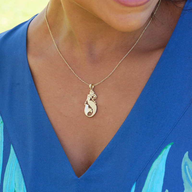 A woman's chest with a Sealife Mermaid Mother of Pearl Pendant in Gold with Diamonds - 30mm - Maui Divers Jewelry