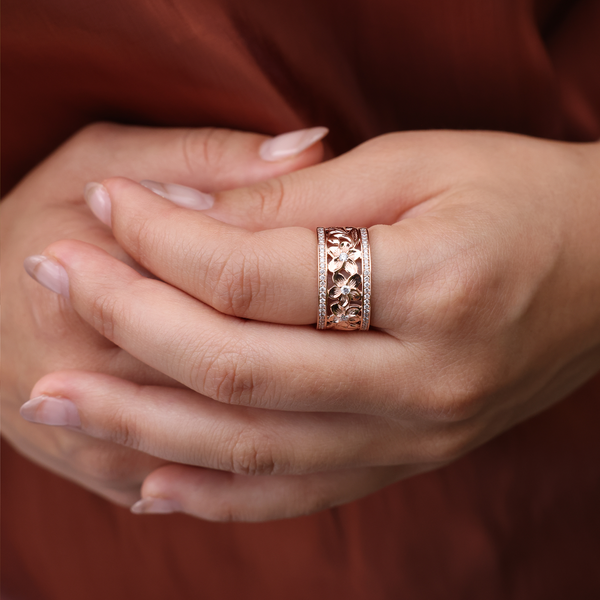 A woman's hand holding a Hawaiian Heirloom Plumeria Ring in Rose Gold with Diamonds - 10mm - Maui Divers Jewelry