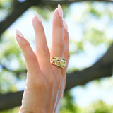 A woman's hand wearing a Hawaiian Heirloom Plumeria Ring in Gold with Diamonds - Maui Divers Jewelry