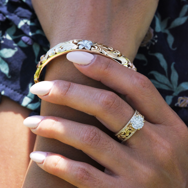 A woman's hand with a Living Heirloom Engagement Ring in Gold with Diamonds - 10mm - and a bracelet - Maui Divers Jewelry