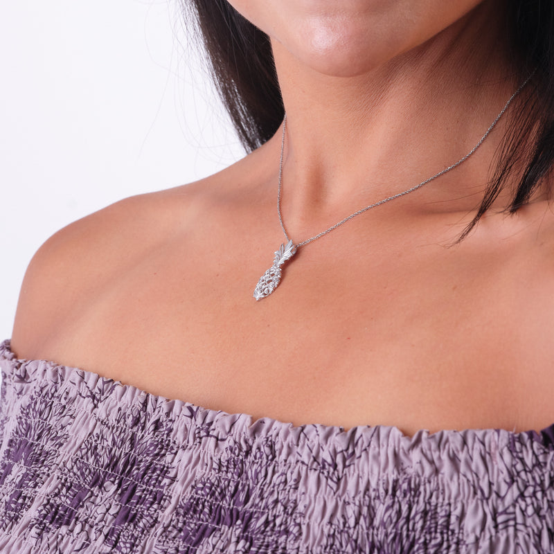 A woman's chest with a Living Heirloom Pineapple Pendant i White Gold - 30mm - Maui Divers Jewelry