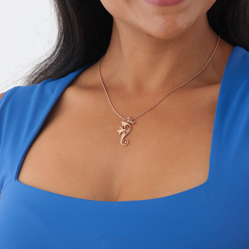 A woman's chest with a Living Heirloom Seahorse Pendant in rose Gold with Diamonds - Maui Divers Jewelry