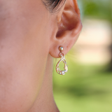 A womanʻs ear with a Living Heirloom Mermaid Earrings in Gold - 19mm - Maui Divers Jewelry