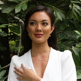 A woman wearing Plumeria Earrings in Gold with Diamonds - 11mm - Maui Divers Jewelry
