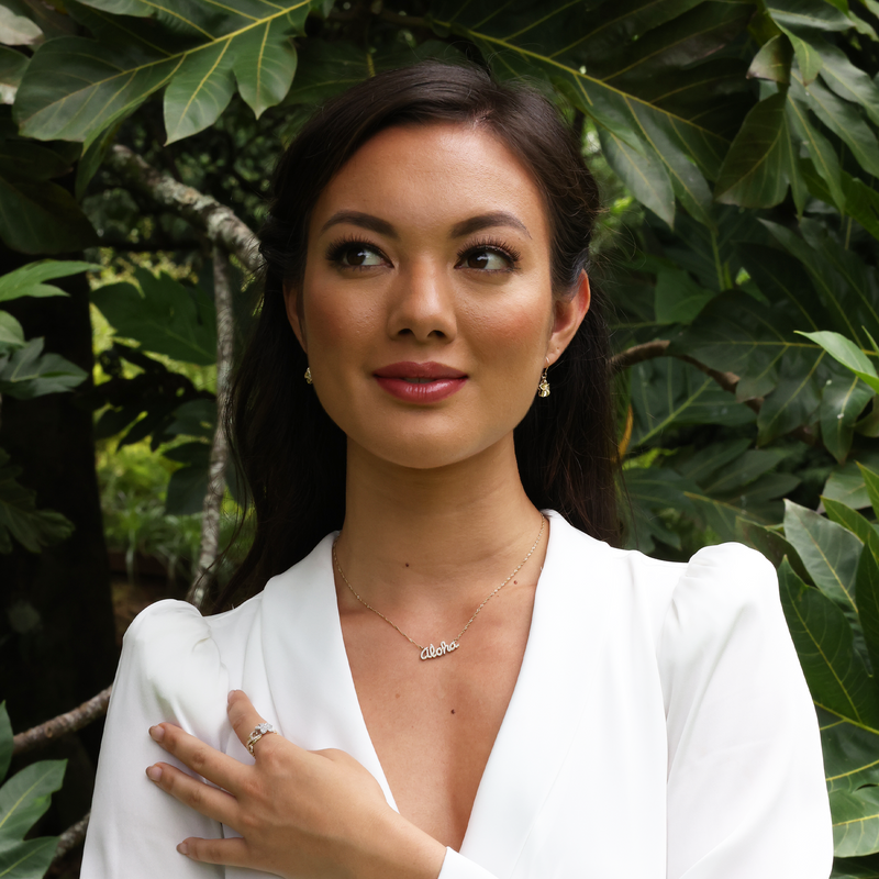 A woman wearing Plumeria Earrings in Gold with Diamonds - 11mm - Maui Divers Jewelry