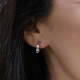 A woman's ear with the Heritage Earrings in White Gold with Diamonds - 13mm - Maui Divers Jewelry