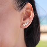A woman's ear with Plumeria Earrings in Tri Color Gold with Diamonds - 19mm - Maui Divers Jewelry