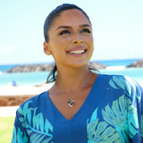 A woman wearing  Plumeria Earrings in Tri Color Gold with Diamonds - 19mm - Maui Divers Jewelry