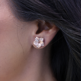 A womanʻs ear with a Hawaiian Gardens Hibiscus Earrings in Rose Gold with Diamonds - Maui Divers Jewelry
