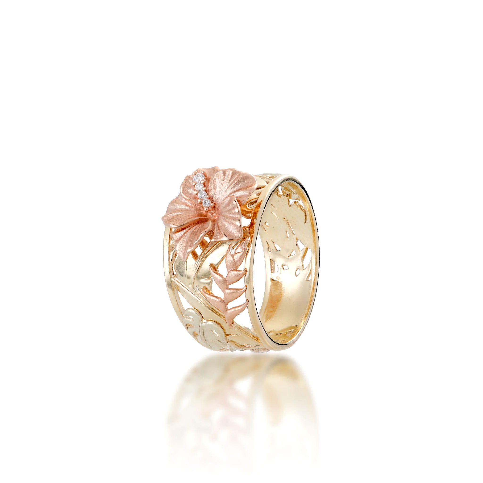 Angle view of a Tapered 12mm Wide Hawaiian Gardens Collection Ring with high-polish 14k yellow gold band, 14k rose gold diamond hibiscus at the crown, 14k rose gold heliconia, and 14k green gold monstera on a white background