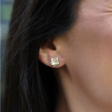 A woman's ear with Hawaiian Gardens Hibiscus Earrings in Gold with Diamonds - 9.5mm- Maui Divers Jewelry