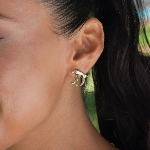 A woman's ear with Ocean Dance Dolphin Earrings in Gold with Diamonds - 18mm - Maui Divers Jewelry