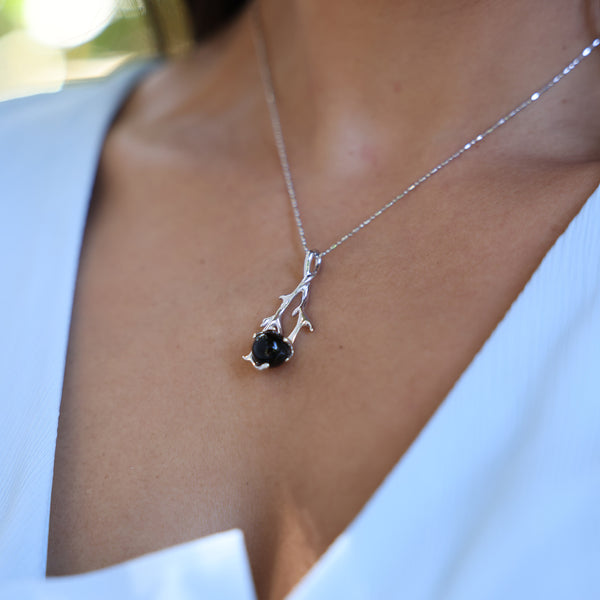 Close up of Heritage Black Coral Pendant in White Gold on neckline