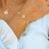 close up of woman wearing Palm Tree Bracelet in Gold with Diamonds