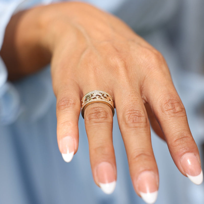 close up of Hawaiian Heirloom Ring in Gold with Diamonds on woman's hand