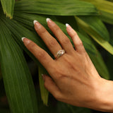 Close up of woman wearing Hawaiian Gardens Hibiscus Ring in Tri Color Gold with Diamonds