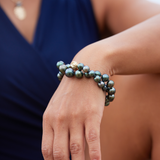 A womanʻs wrist with a Tahitian Black Pearl Strand with Magnetic Gold Clasp - 8-12mm - Maui Divers Jewelry