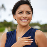 A woman wearing a Monstera Pendant in Rose Gold - 30mm - Maui Divers Jewelry