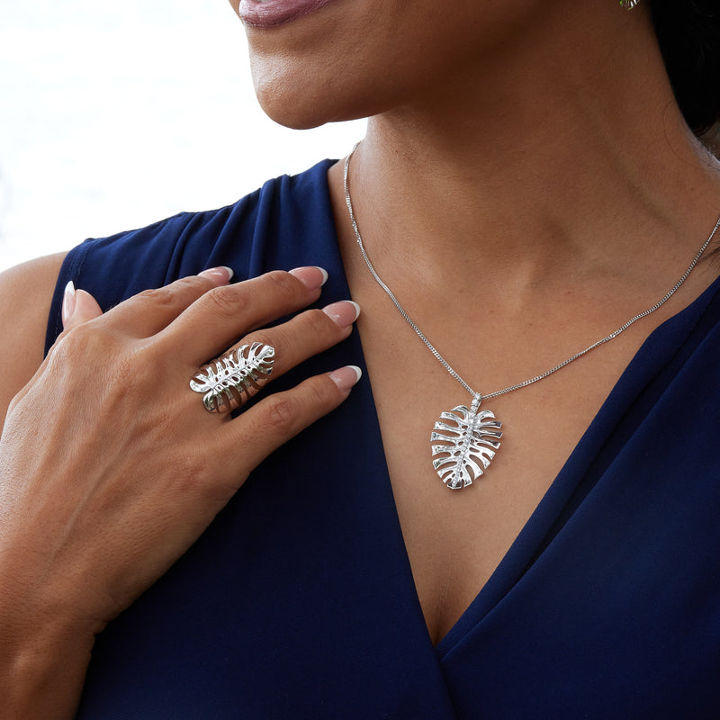 A woman wearing a 1.5mm Gourmette Chain in White Gold with a Monstera Pendant and a Monstera Ring- Maui Divers Jewelry
