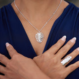 A woman's chest with a Monstera Pendant in White Gold - 30 mm - Maui Divers Jewelry
