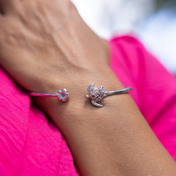 A woman's hand with a Honu and Plumeria Bracelet in Sterling Silver-Maui Divers Jewelry