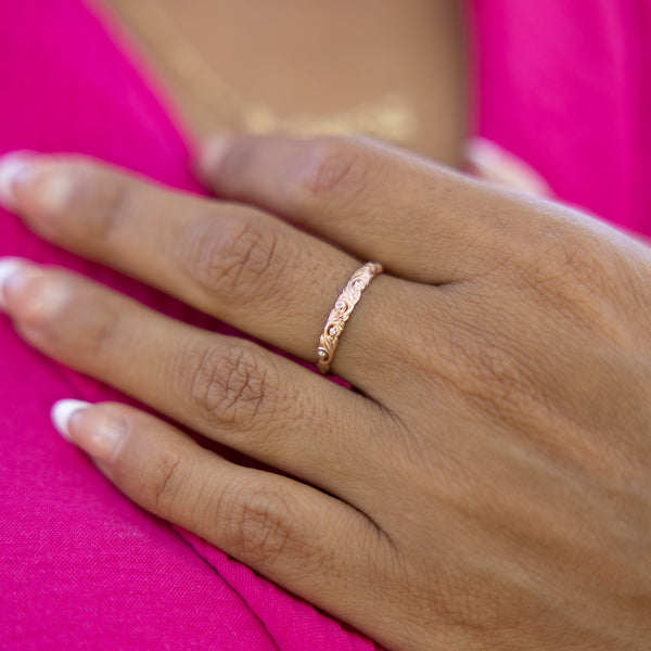 A woman's hand wearing a Living Heirloom Ring in Rose Gold with Diamonds - 3mm - Maui Divers Jewelry