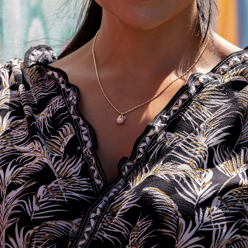 A woman wearing a Ohia Lehua Ruby Pendant in Two Tone Gold - 15 mm - Maui Divers Jewelry