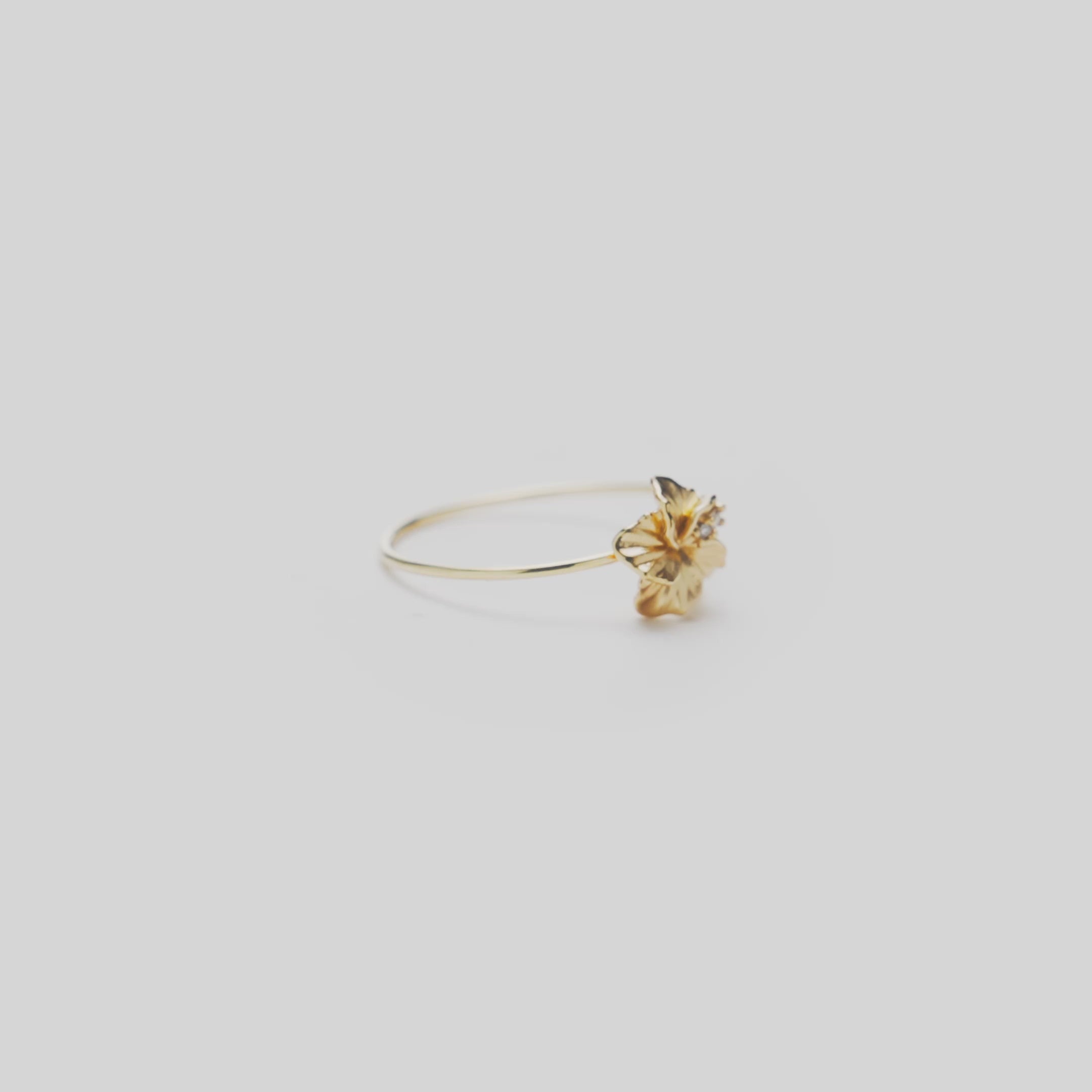 8mm Hawaiian Gardens Hibiscus Ring in 14k Yellow Gold with Diamonds on a white turntable