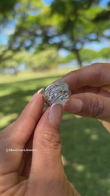 Video of a woman's hand holding a Hawaiian Heirloom Plumeria Ring in White Gold with Diamonds - 10mm - Maui Divers Jewelry