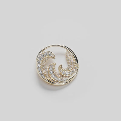 Video of diamond encrusted Nalu pendant with triple wave design on white turn table