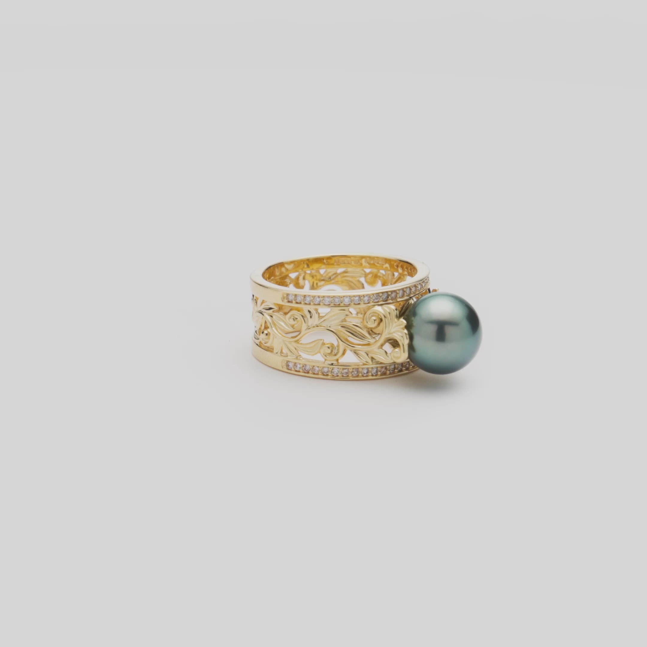 Video of the 10mm Living Heirloom Tahitian Black Pearl Ring in Gold with Diamonds turning on a white background