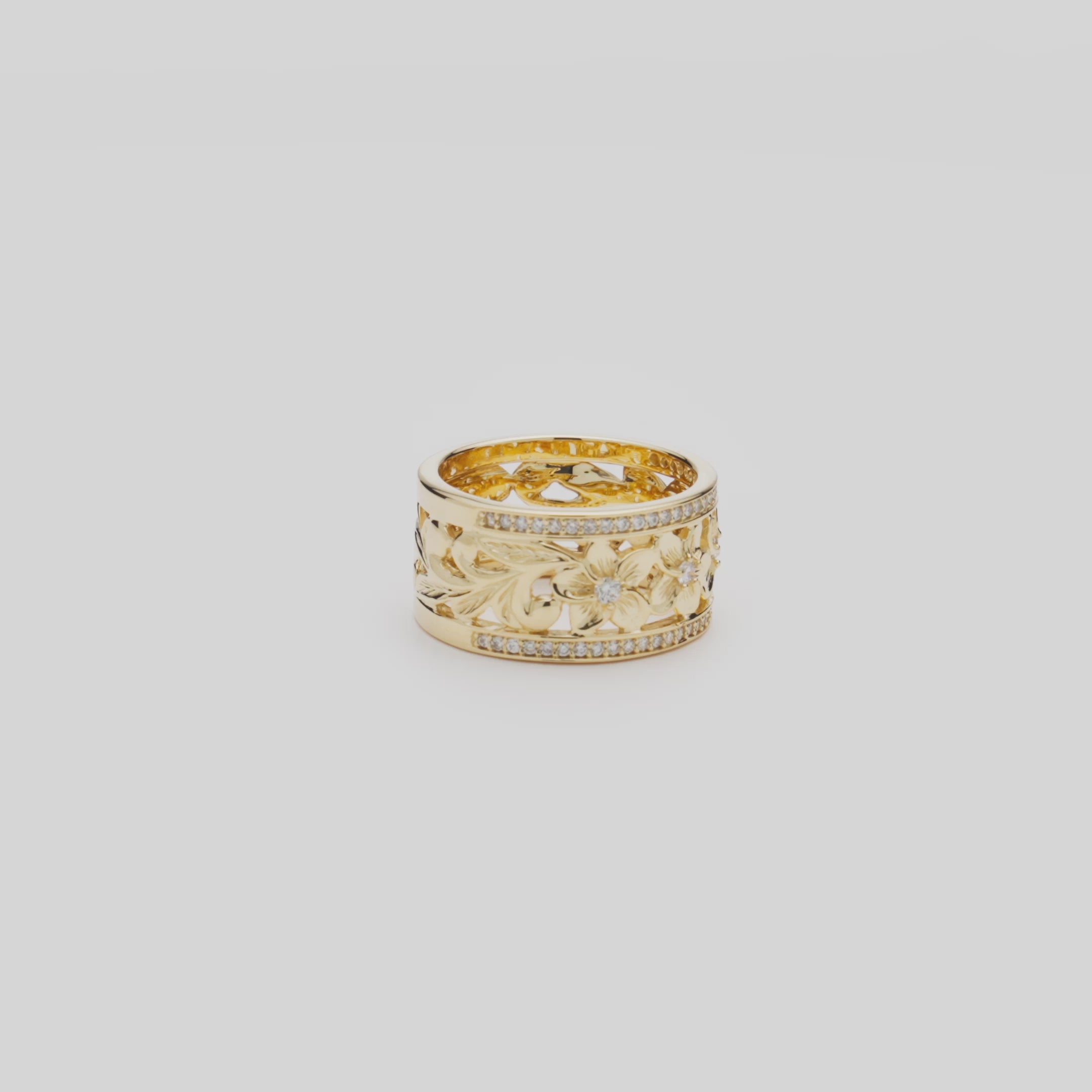 Video of the 10mm Hawaiian Heirloom Plumeria Ring in 14k Yellow Gold with Diamonds turning on a white background