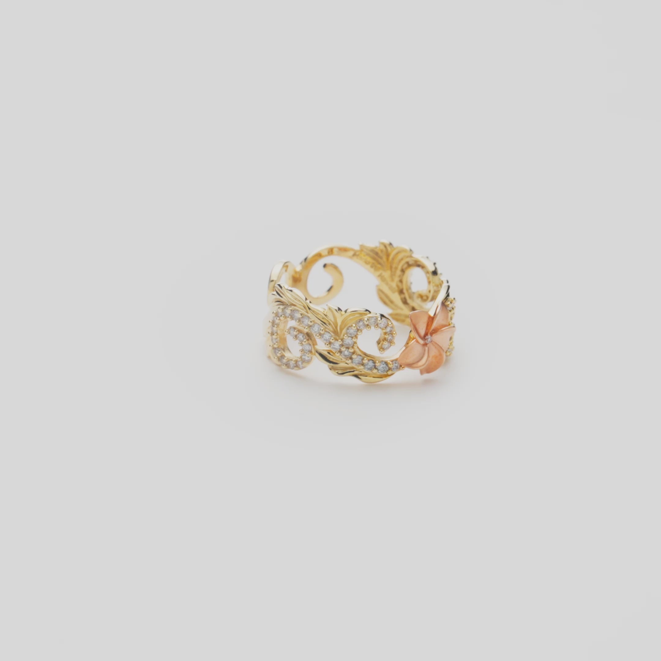 Hawaiian Heirloom Plumeria Ring in Two Tone Gold with Diamonds on a white turntable